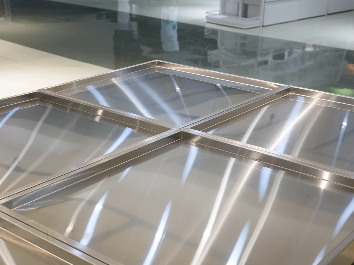 Close-up of the grid of divided stainless trays on the island deck