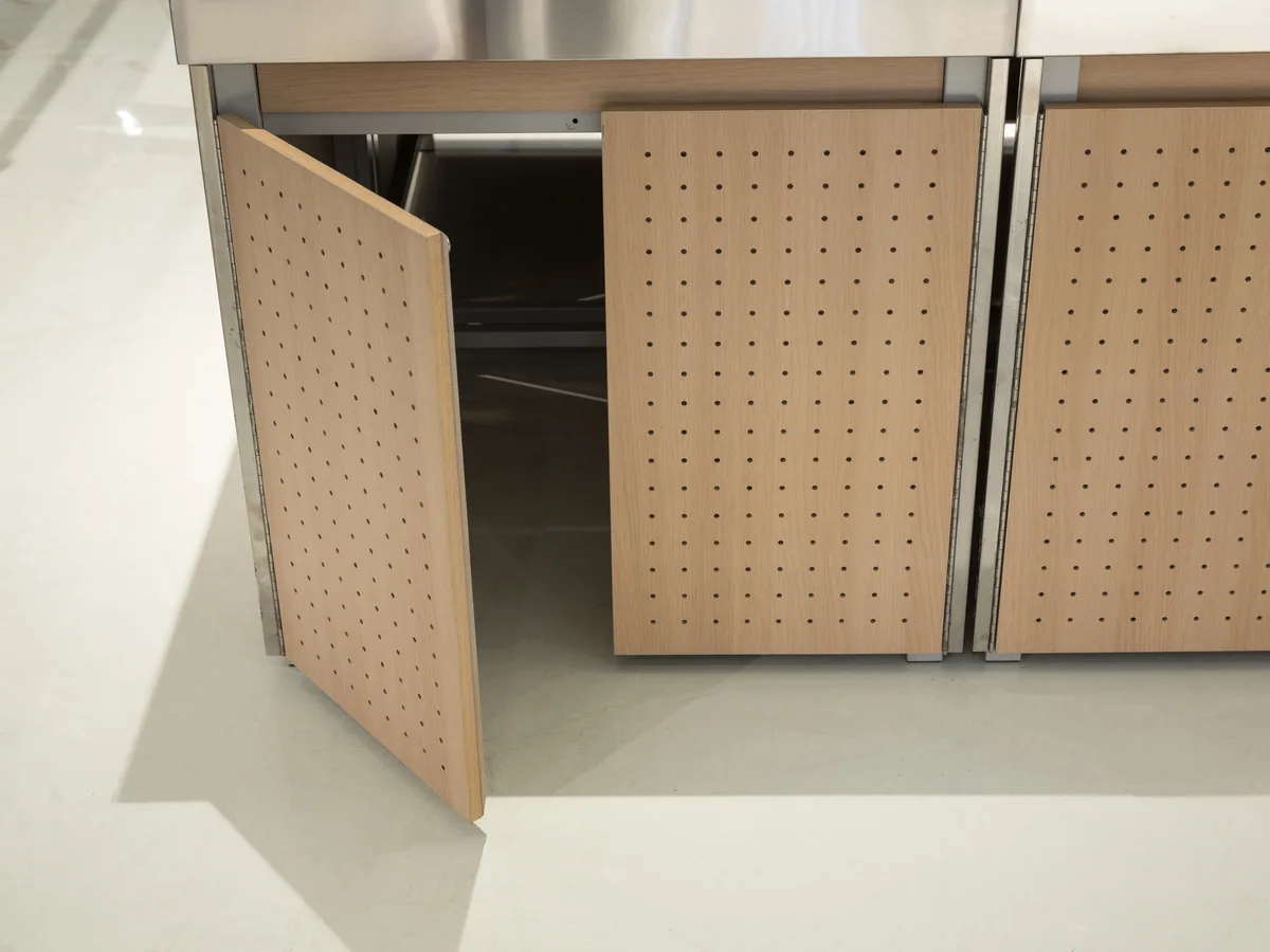 Close-up of the edge of a single stainless tray where it meets the next