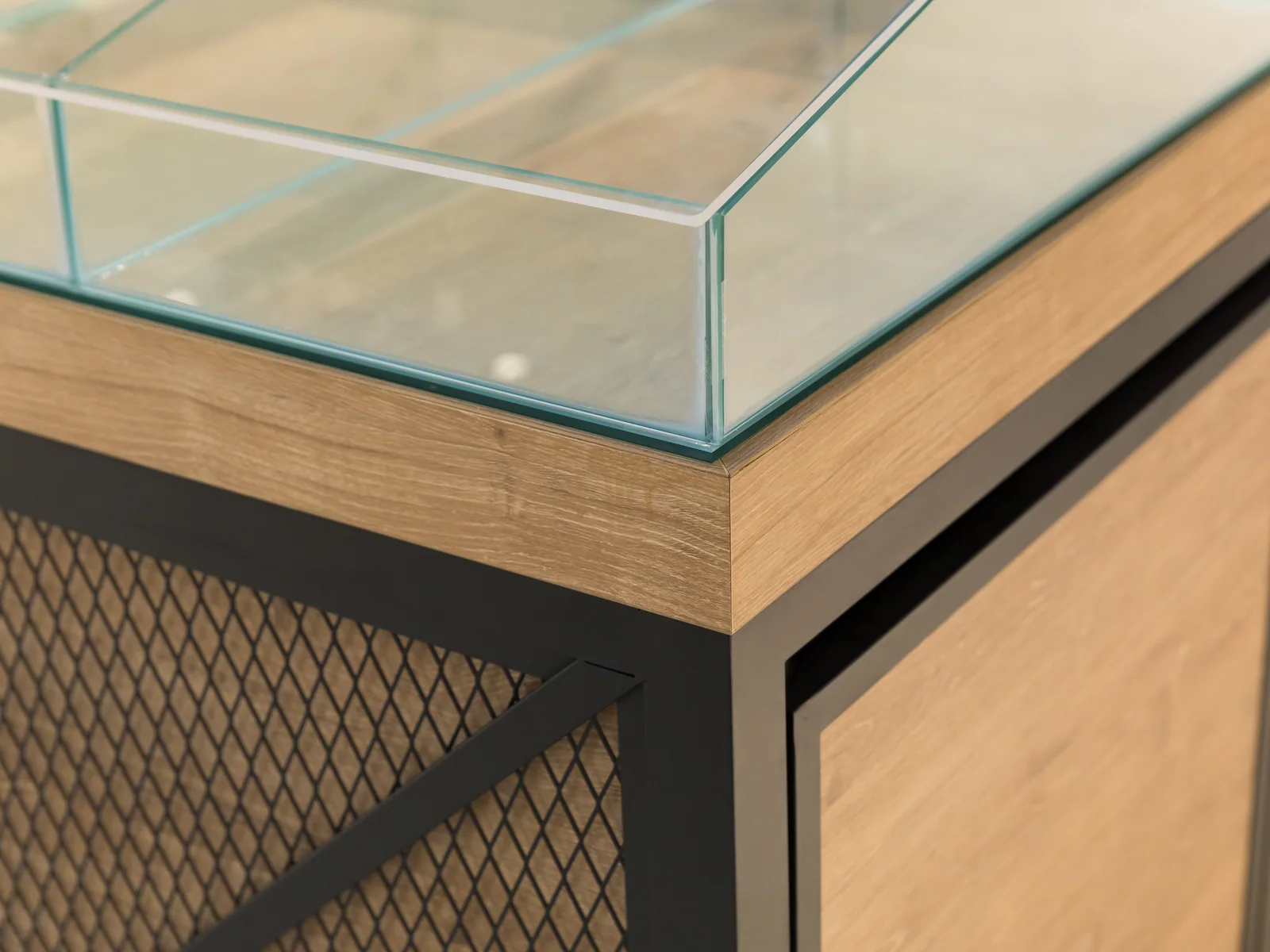 Grain cabinet photographed from a corner showing the mesh sides and glazed top