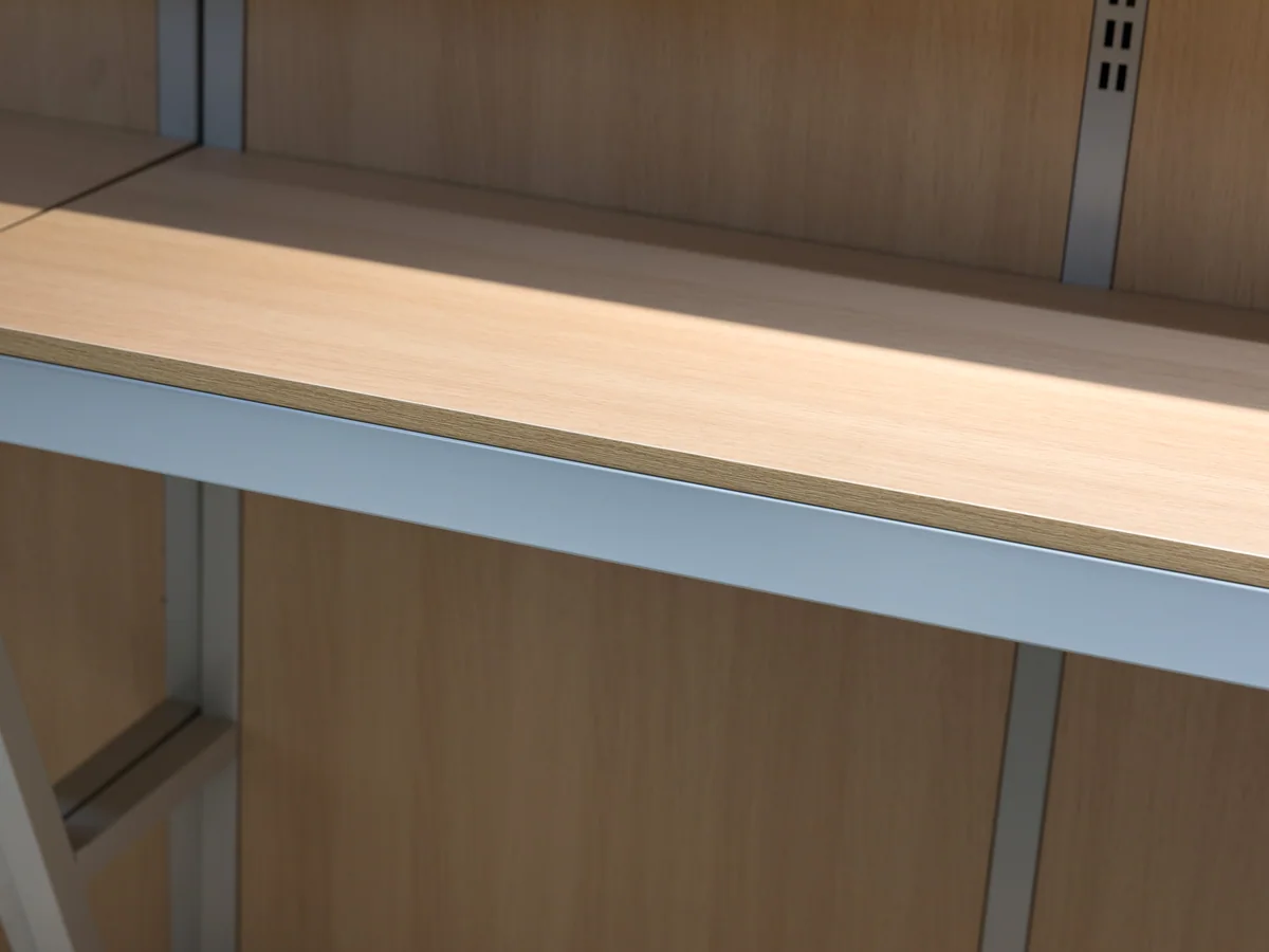 Close-up of a pale timber shelf in the wall run