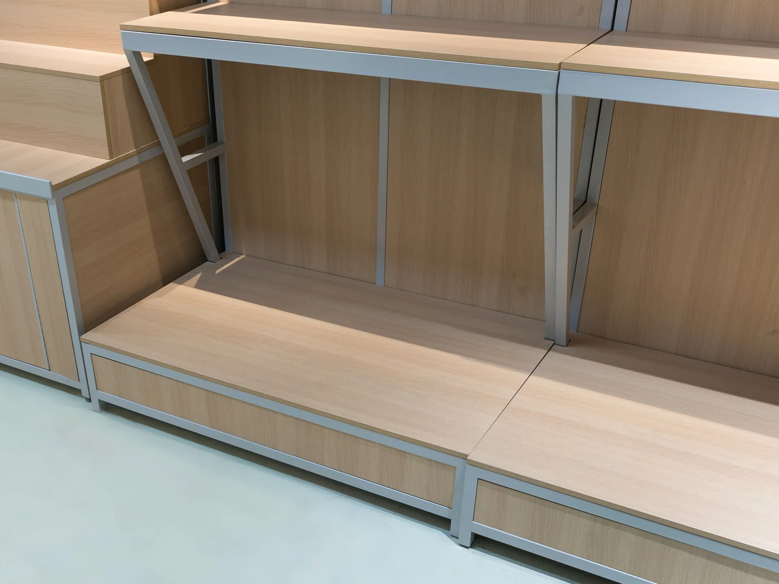 Wall grain shelving photographed straight on showing the open base under the shelves