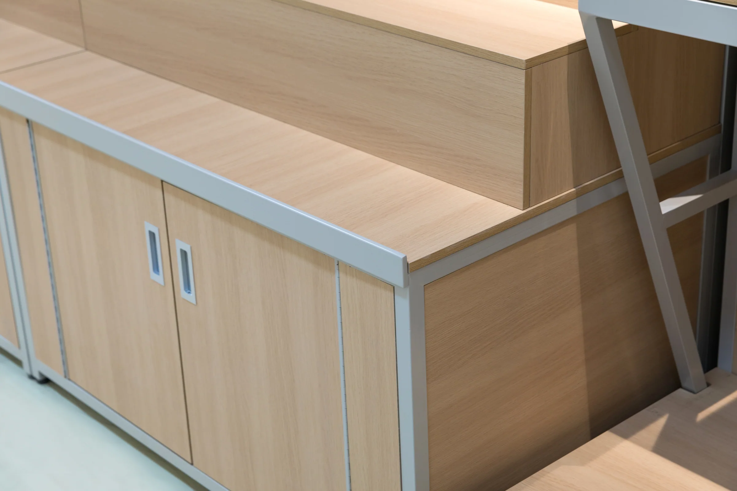 Keshun single sided grain shelving with pale timber shelves above closed base cabinets
