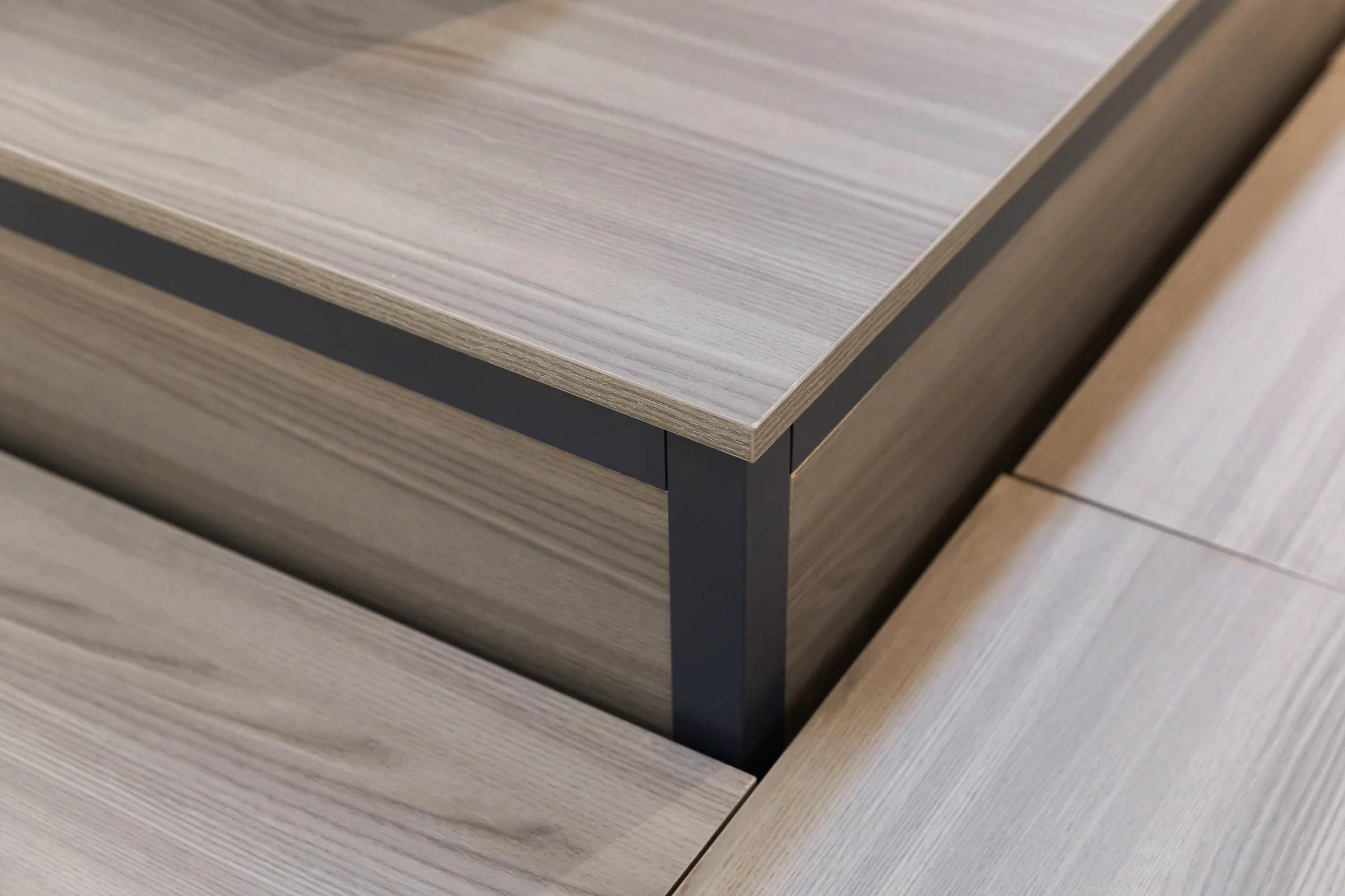 Keshun stepped dark timber promotional stand with hexagonal display risers and cubby storage