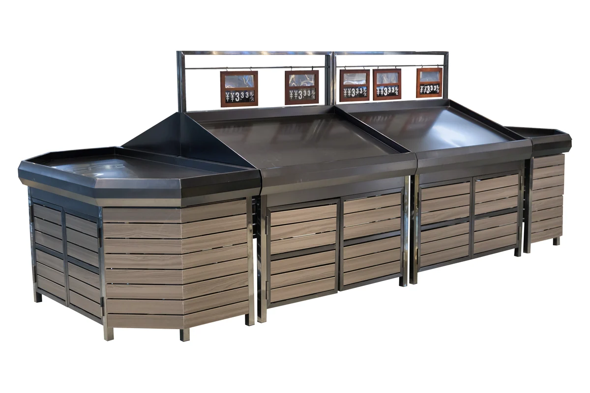 Angled corner supermarket produce island with slatted wooden flanks and overhead sign frames