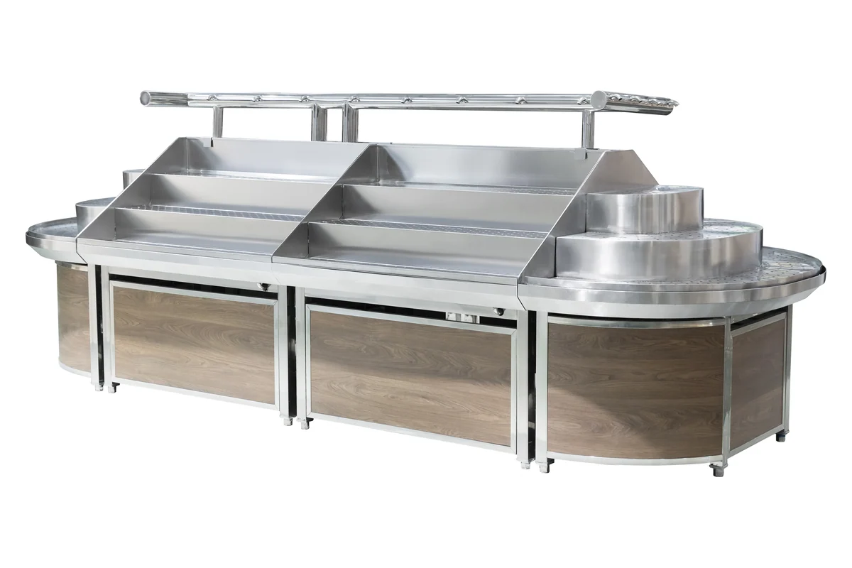Curved stainless steel supermarket produce island with a rounded end and timber panelling