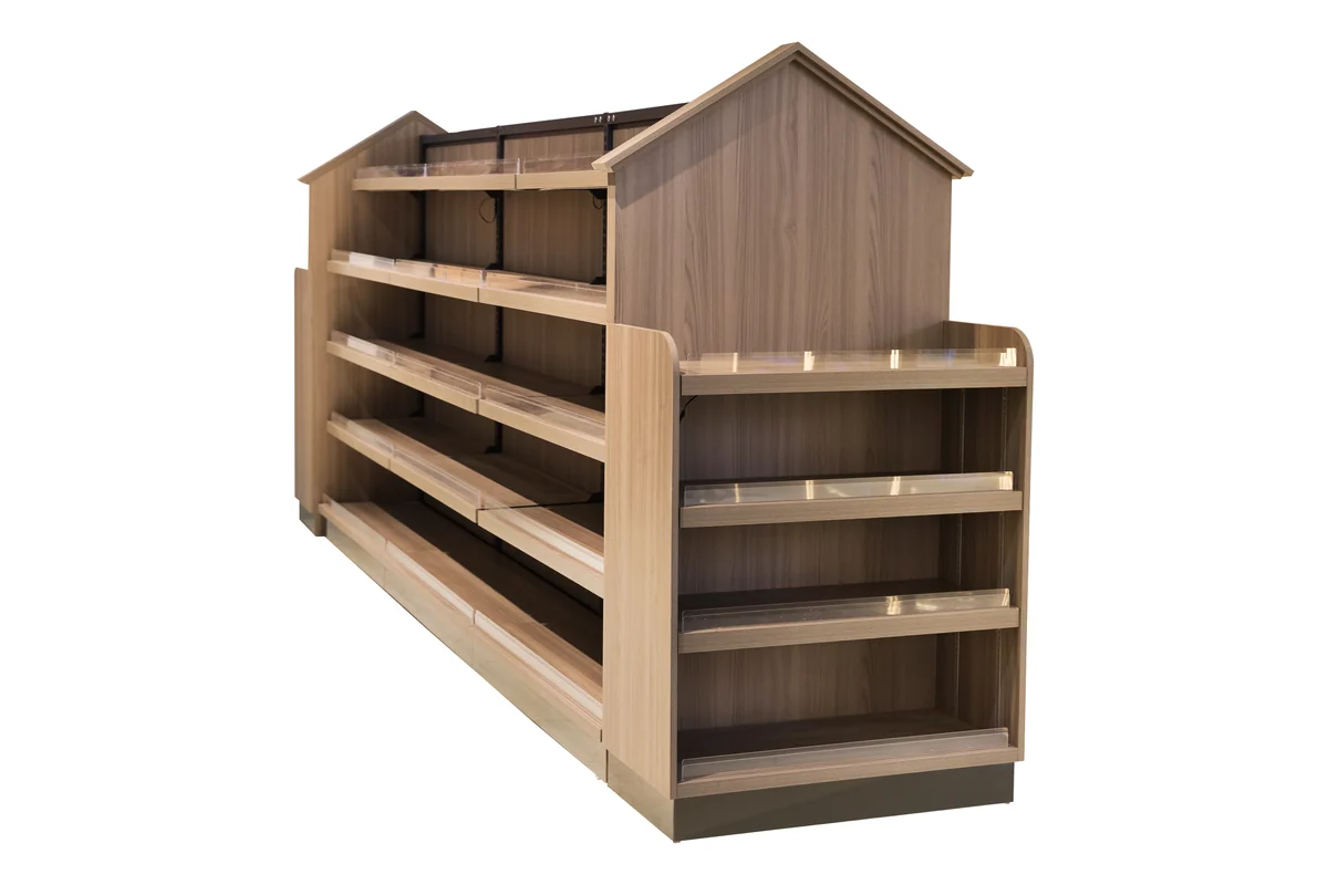 Light timber supermarket shelving run with a pitched roof feature over the end bay
