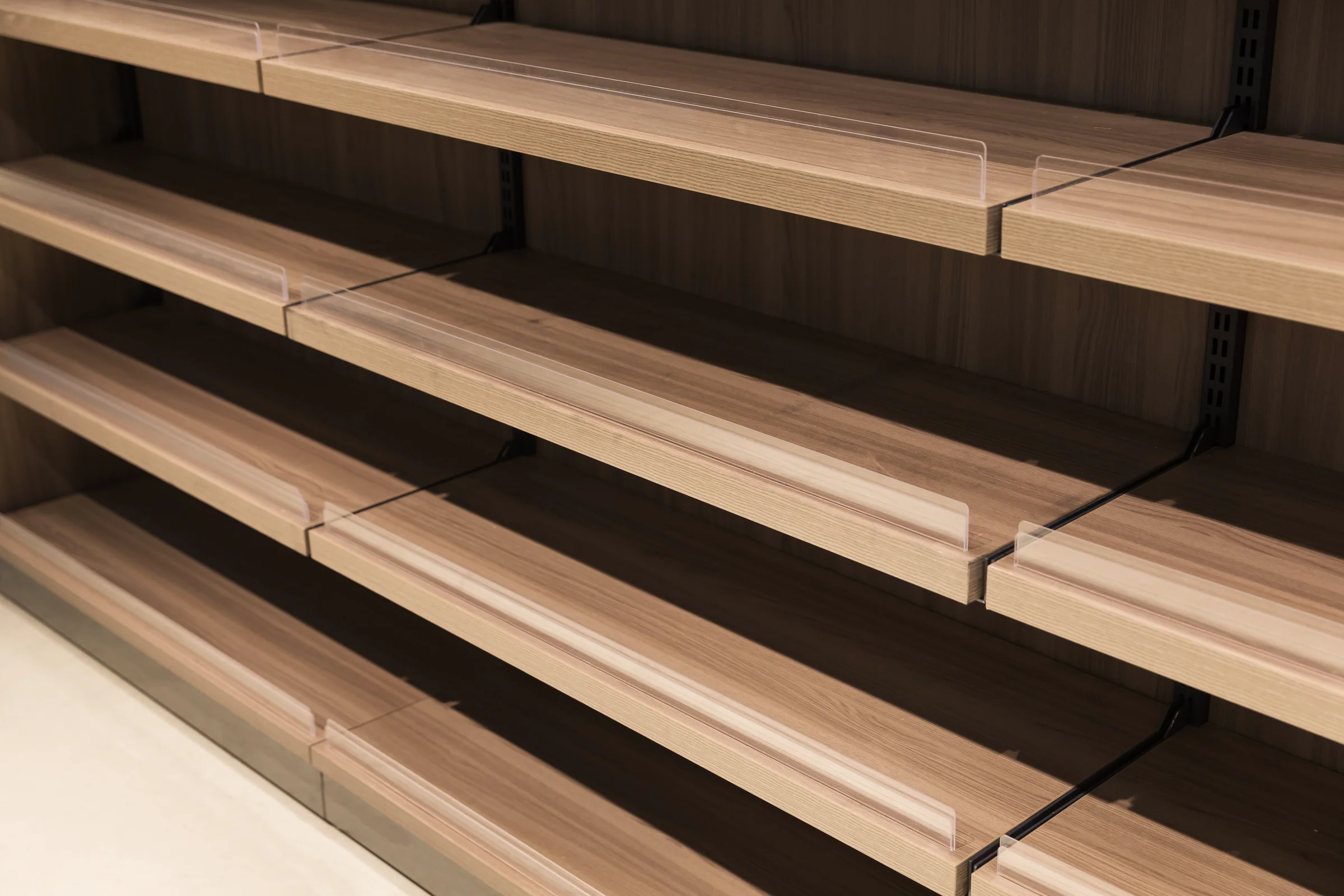 Keshun pale timber shelving bay with a pitched house-shaped header marking the department