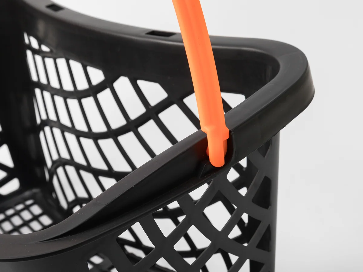 Close-up of the pivot where the handle meets the basket rim