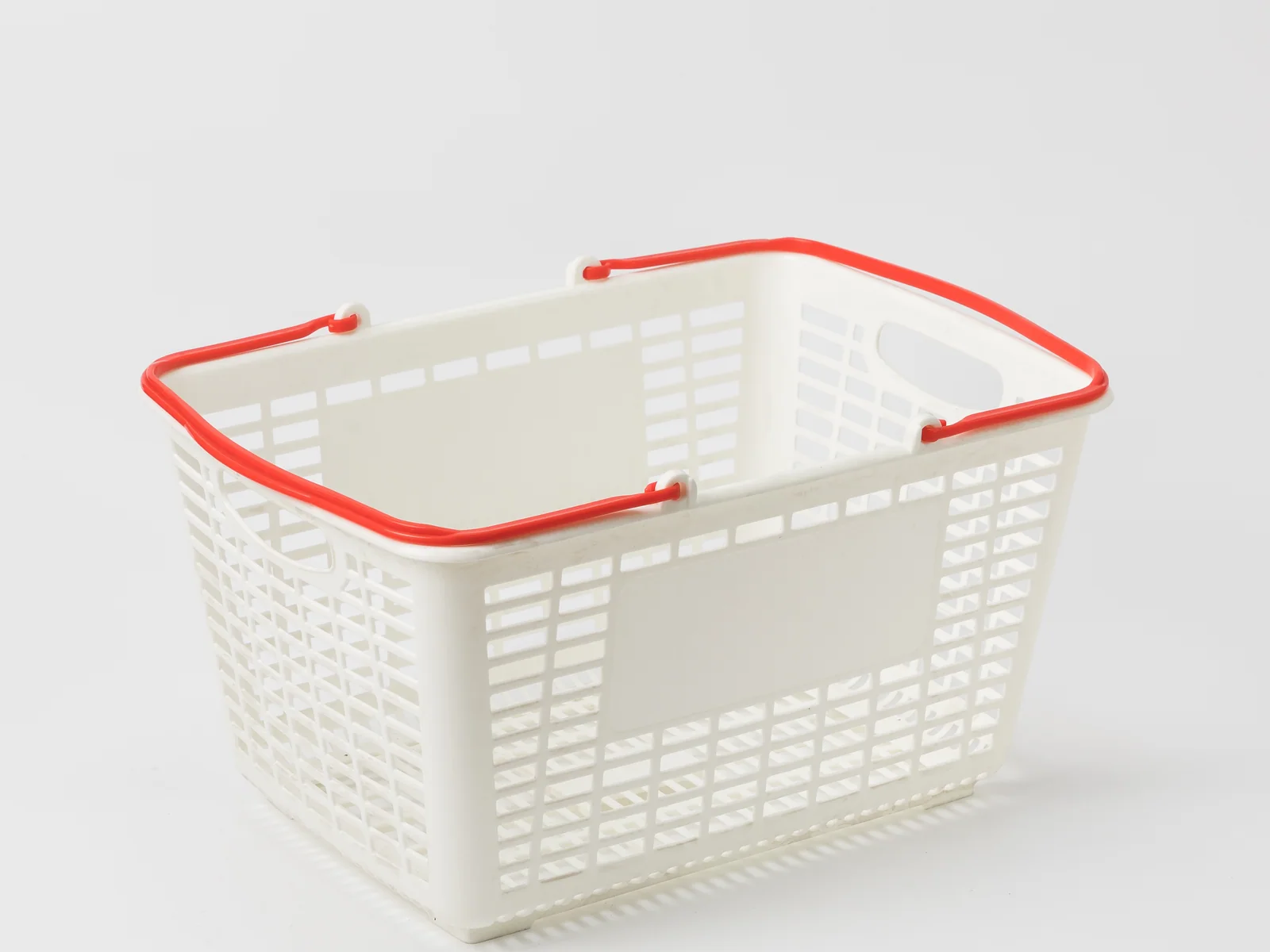 White Hand Basket with Red Handles photographed on a white studio background