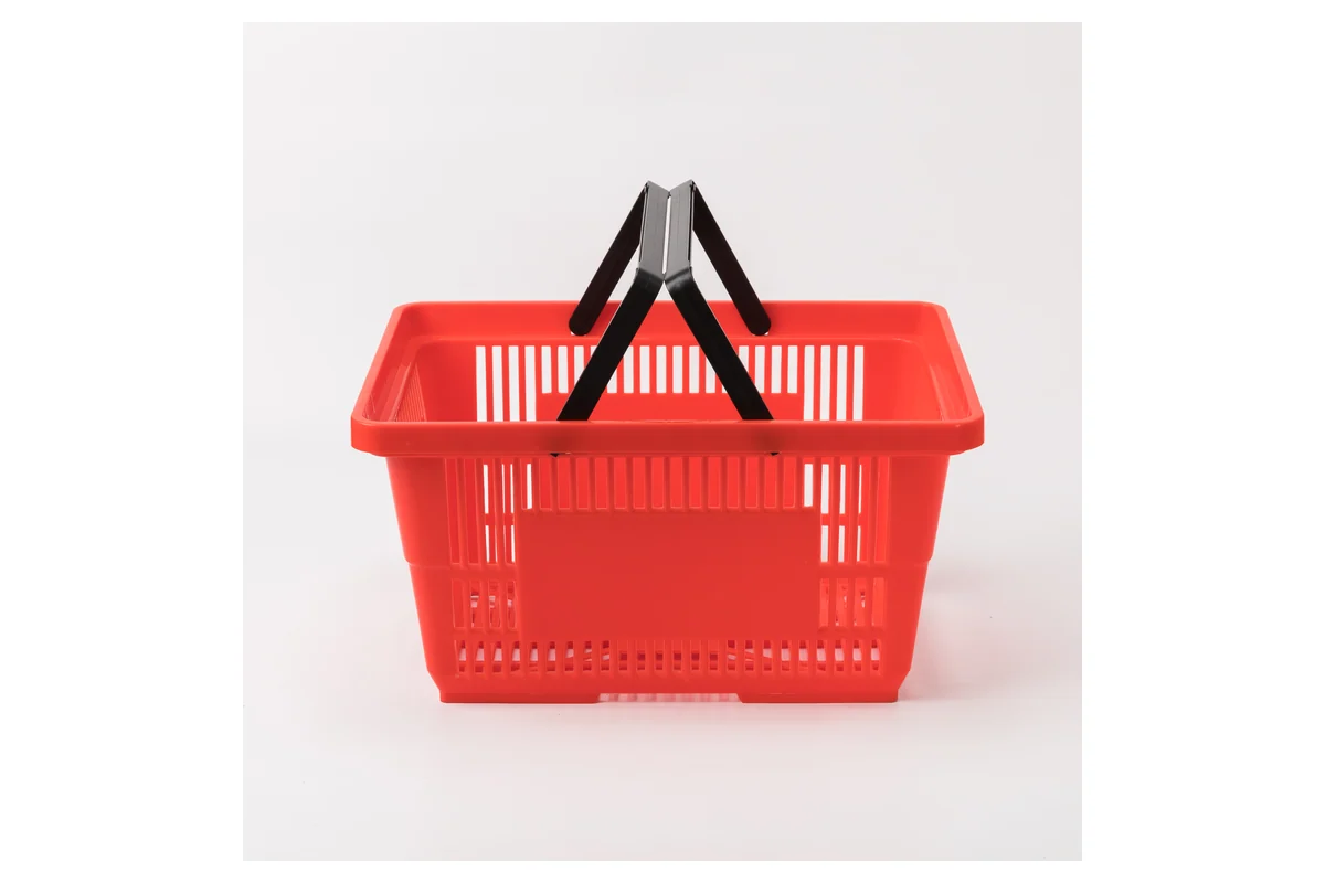 Red moulded supermarket hand basket with black twin folding handles