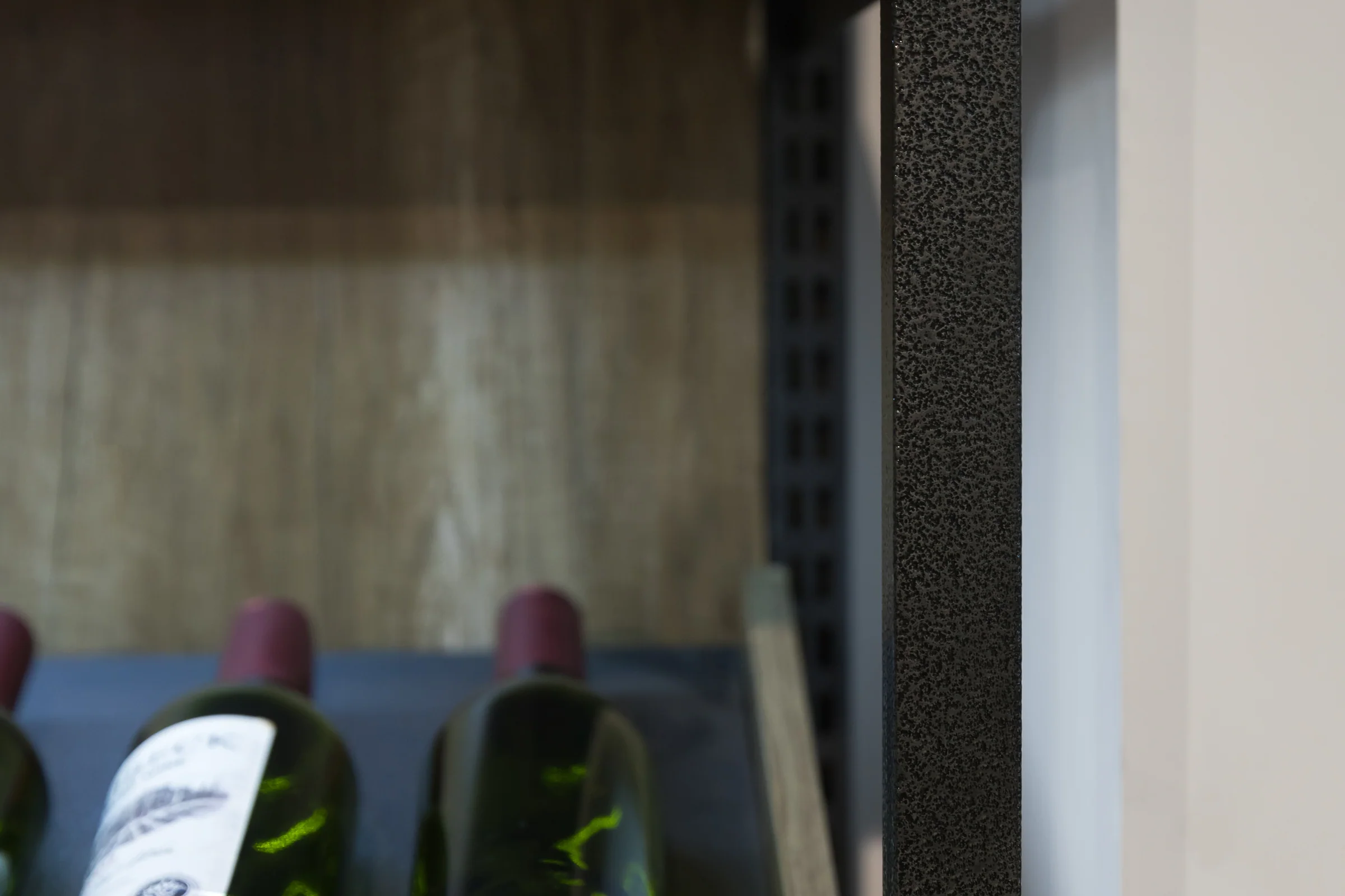 Keshun full height wine wall with lit display shelves, cellular racks and a diamond lattice base