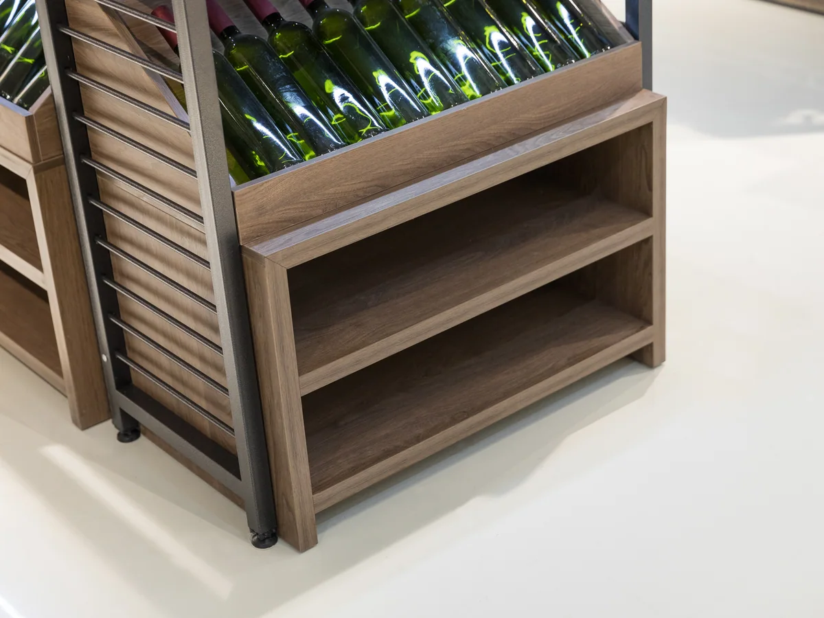 Close-up of an angled bottle shelf presenting labels forward