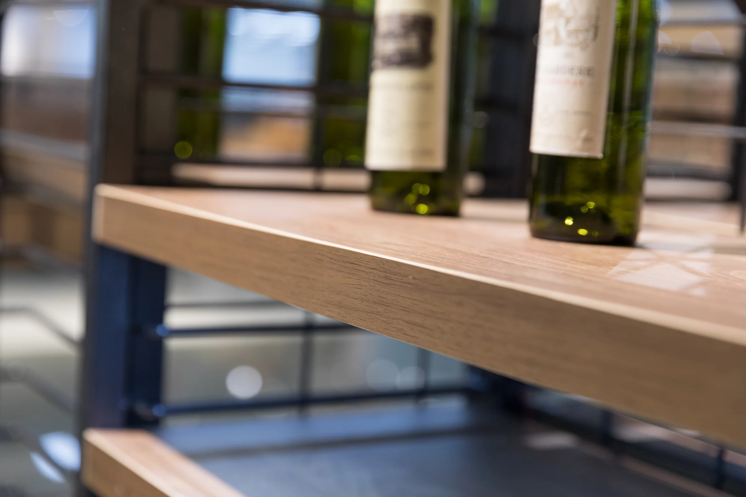 Keshun wine display with angled label-out shelves under decorative fretwork panels