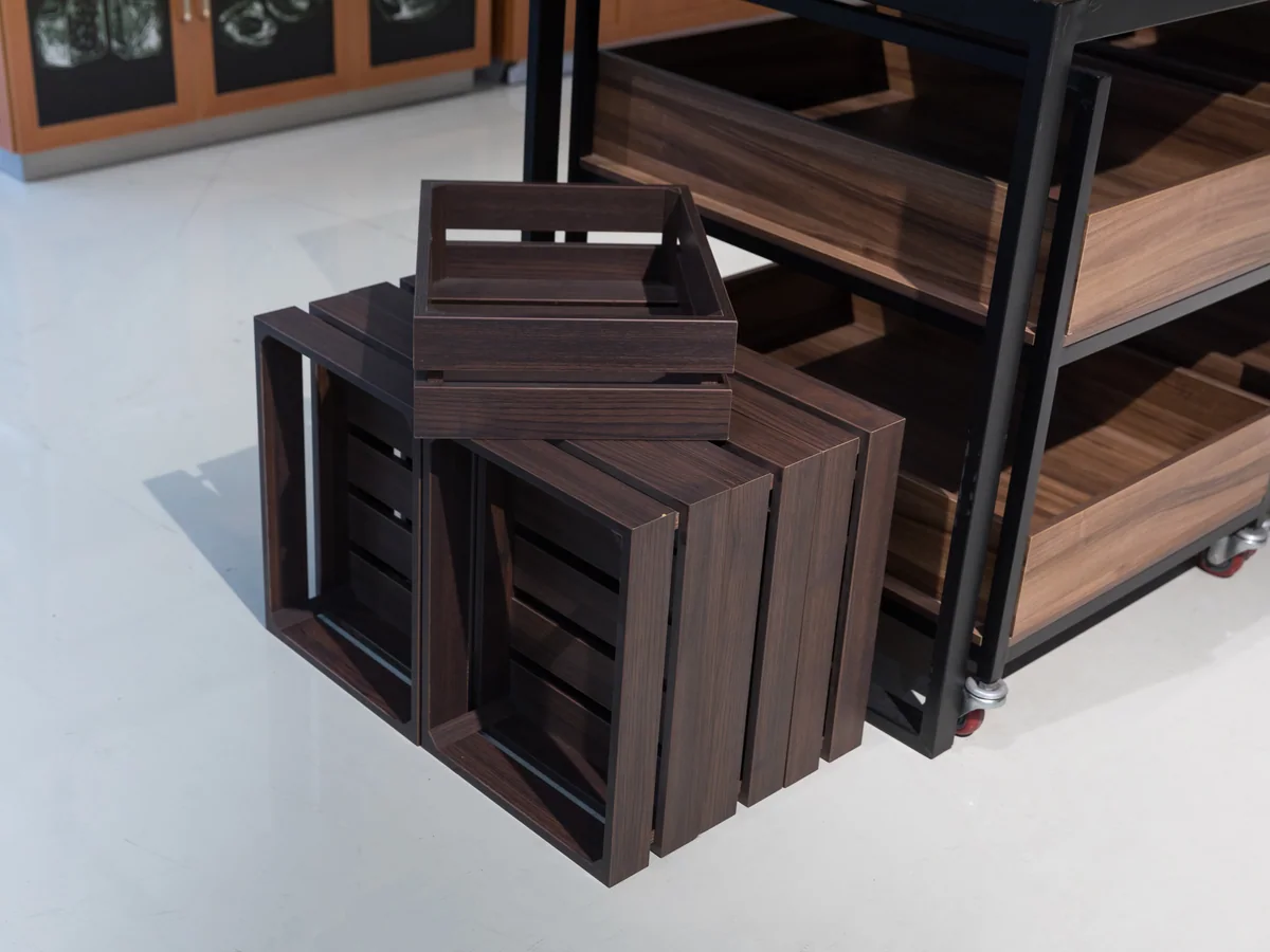Close-up of the black crates stored below the table